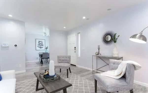 a living room with furniture and wooden floor