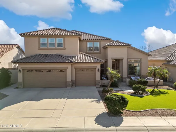 a front view of a house with a fountain