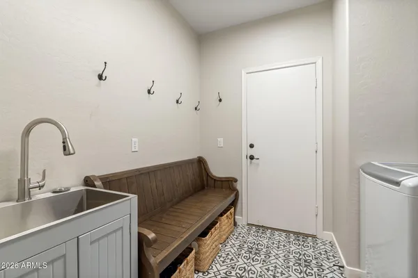 a bedroom with a bed a dresser and wooden floor