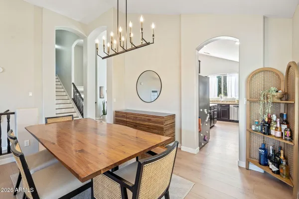 a view of a dining room with furniture and a chandelier