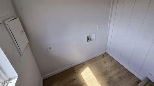 a view of a bathroom with wooden floor and mirror