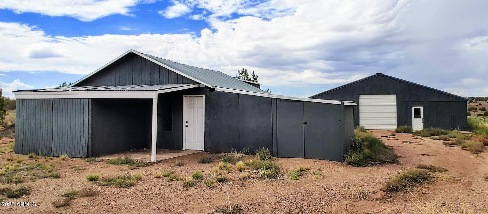 5214 Sour Dough Road Snowflake, AZ 85937 - Photo 6 of 30 a wooden house with a large tree in front of it