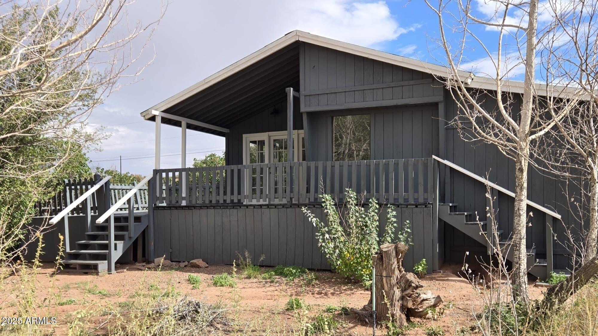 5214 Sour Dough Road Snowflake, AZ 85937 - Photo 8 of 30 a view of a house with a wooden fence and trees