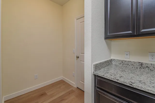 a view of an empty room with glass door and windows