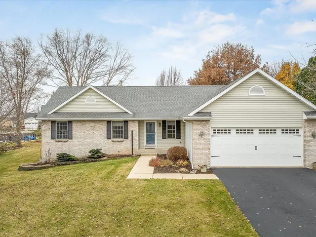 a view of a house with backyard and trees