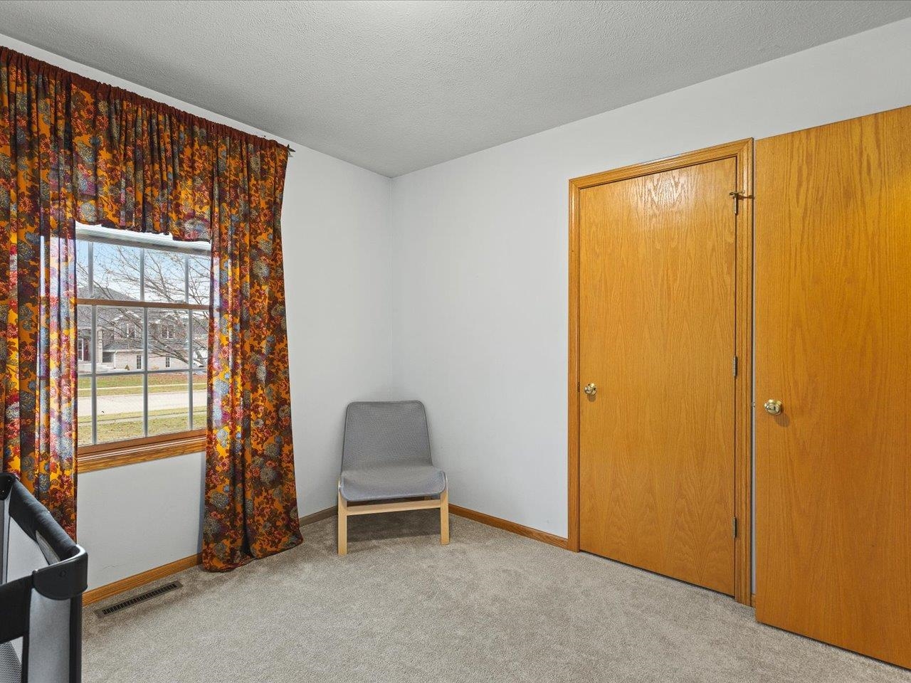 919 Gregory Way Winnebago, IL 61088 - Photo 17 of 47 a view of room with window and chair