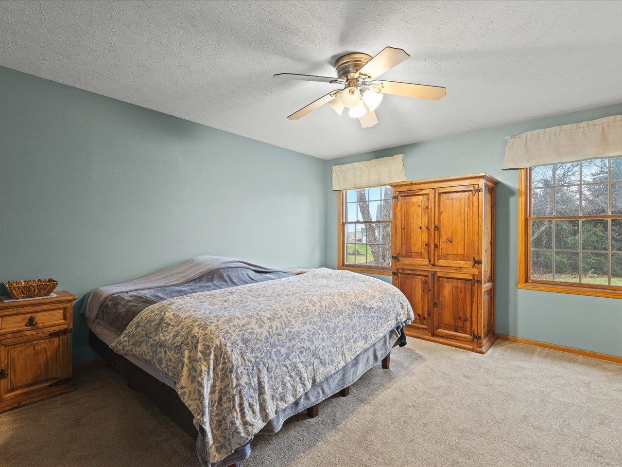 919 Gregory Way Winnebago, IL 61088 - Photo 21 of 47 a bedroom with a bed and a chandelier