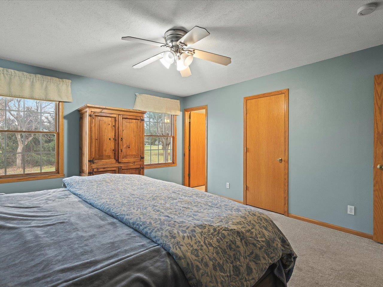 919 Gregory Way Winnebago, IL 61088 - Photo 22 of 47 a bedroom with a large bed and a chandelier