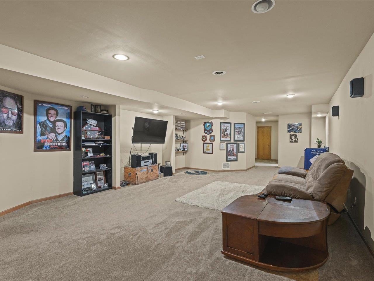 919 Gregory Way Winnebago, IL 61088 - Photo 26 of 47 a living room with furniture and a flat screen tv