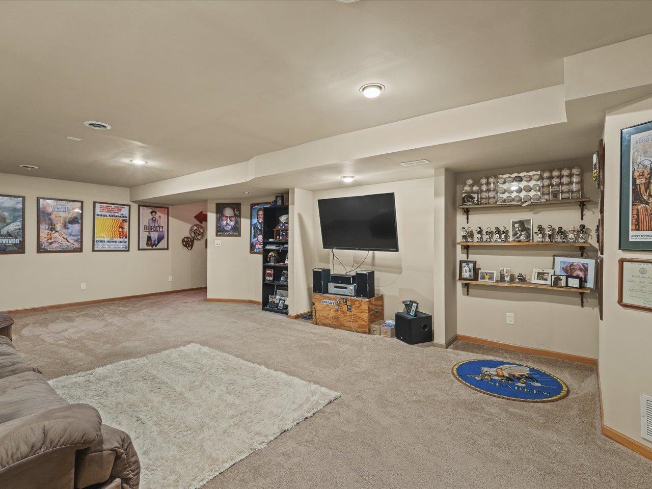 919 Gregory Way Winnebago, IL 61088 - Photo 27 of 47 a living room with furniture and a flat screen tv