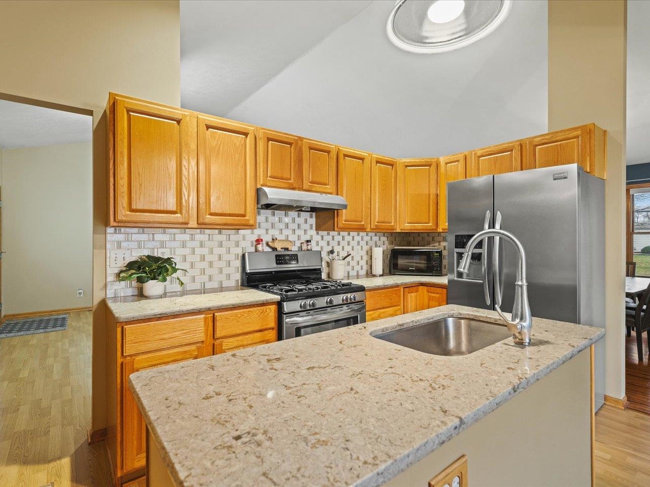 919 Gregory Way Winnebago, IL 61088 - Photo 10 of 47 a kitchen with stainless steel appliances granite countertop a sink a stove and refrigerator