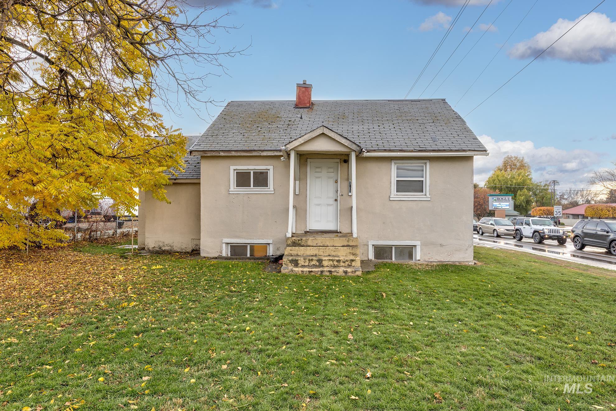 1602 2nd Avenue South Payette, ID 83661 - Photo 2 of 28 View of front of property with stucco siding, a front yard, a chimney, and entry steps