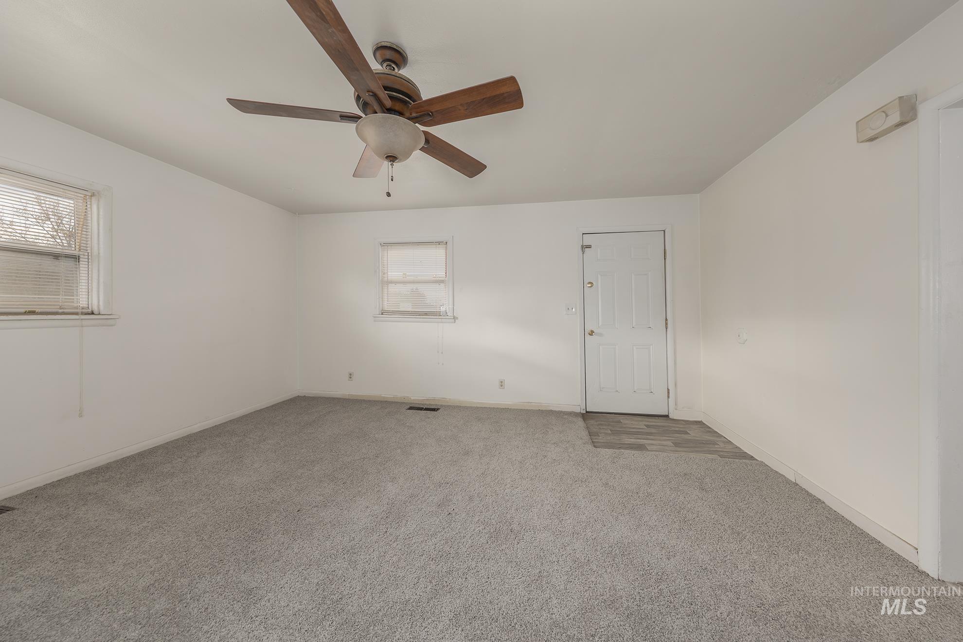 1602 2nd Avenue South Payette, ID 83661 - Photo 9 of 28 Carpeted spare room featuring baseboards and ceiling fan