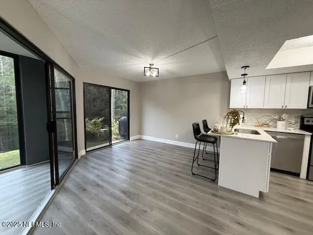 a kitchen with a sink cabinets and wooden floor
