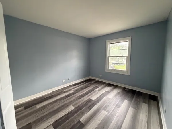 a view of an empty room and a window