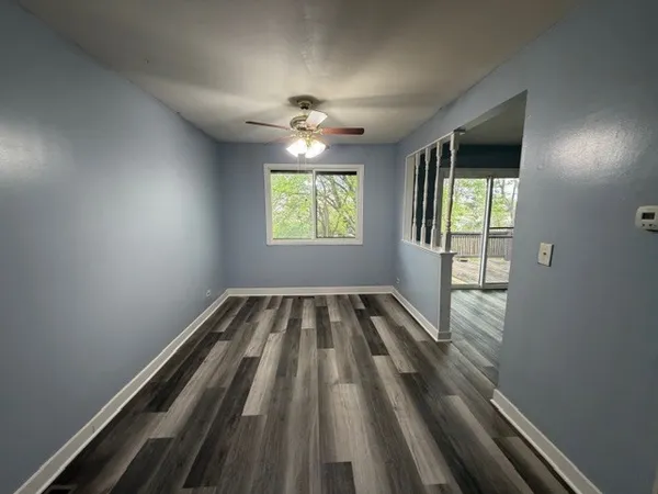 a view of room with window and ceiling fan