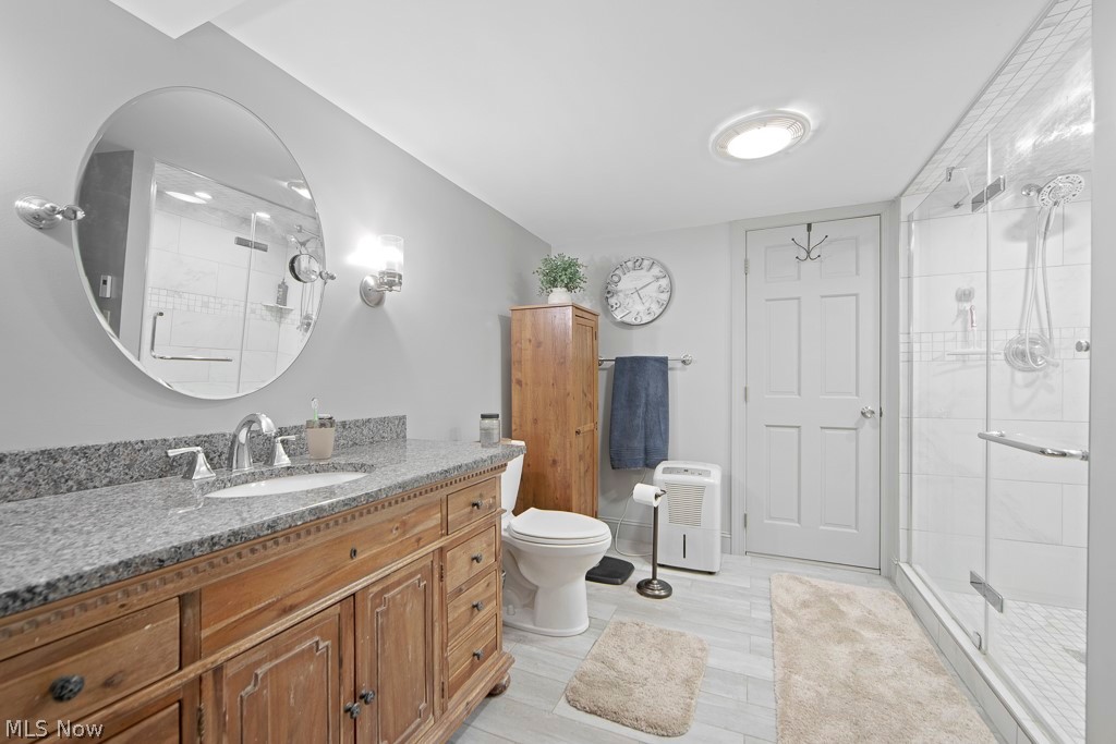 2547 Georgetown-Damascus Road Beloit, OH 44609 - Photo 33 of 49 Bathroom featuring an enclosed shower, vanity, and toilet