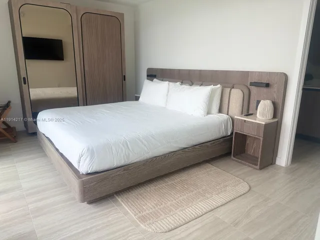a view of a hallway with wooden floor and furniture