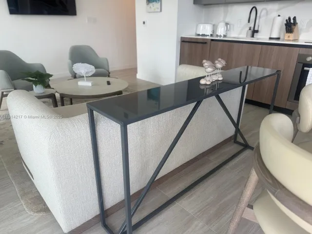 a living room with furniture and a floor to ceiling window