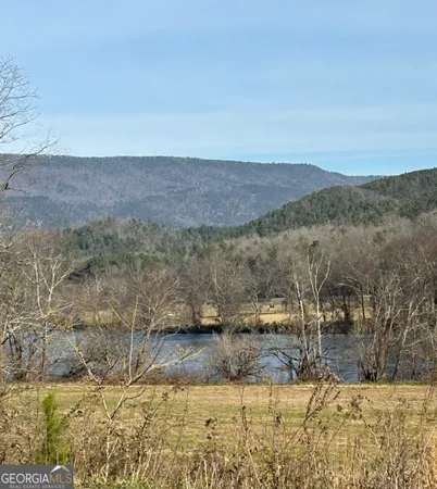 a view of a yard with mountains in the background