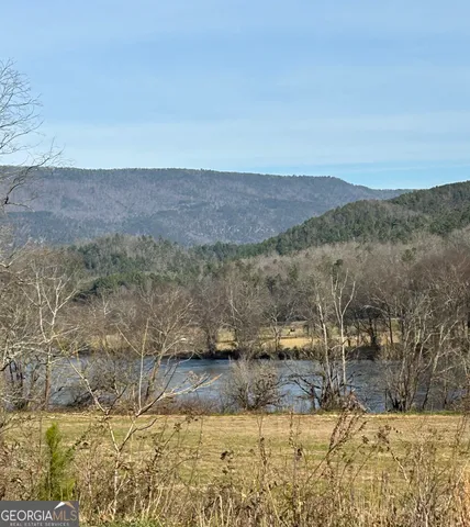 a view of a yard with mountains in the background