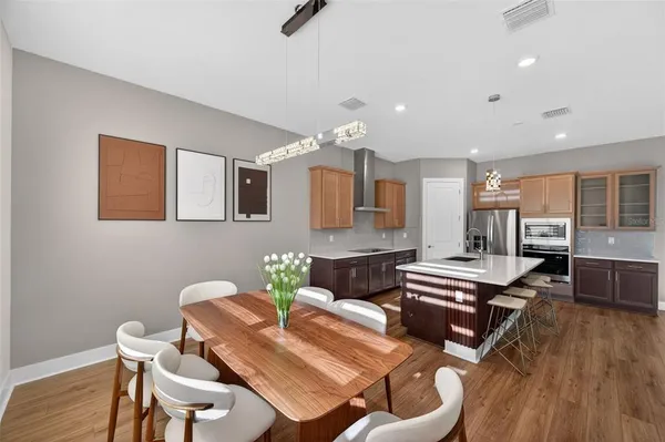 a view of a dining room with furniture and wooden floor