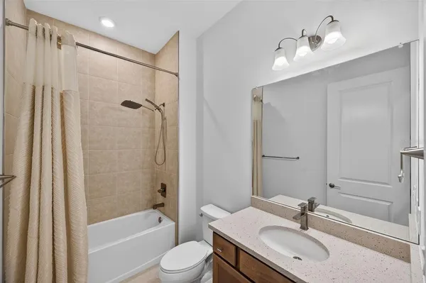 an empty room with a mirror and a fan