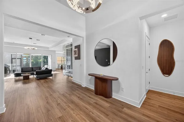 a view of living room with furniture and a wooden floor