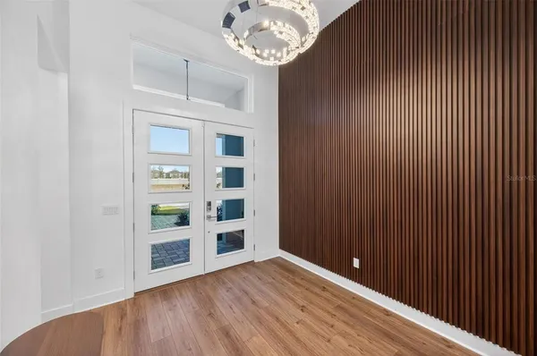 a view of a hallway with wooden floor and closet