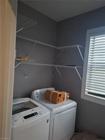 a bedroom with a bed a mirror and a flat tv screen on a dresser