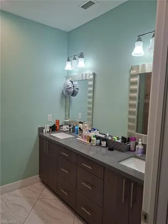 a bedroom with a bed a desk and chair