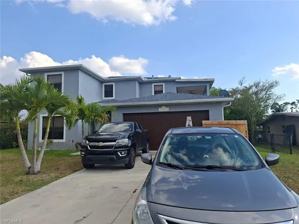 a backyard of a house with table and chairs