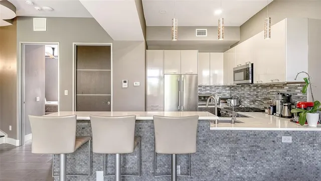 a kitchen with a refrigerator and a sink