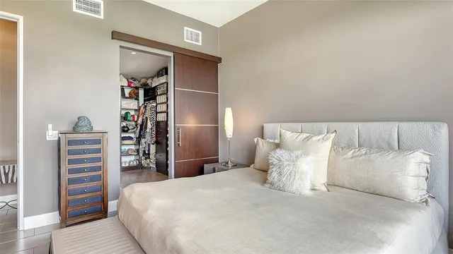 a large bedroom with a bed and a couch