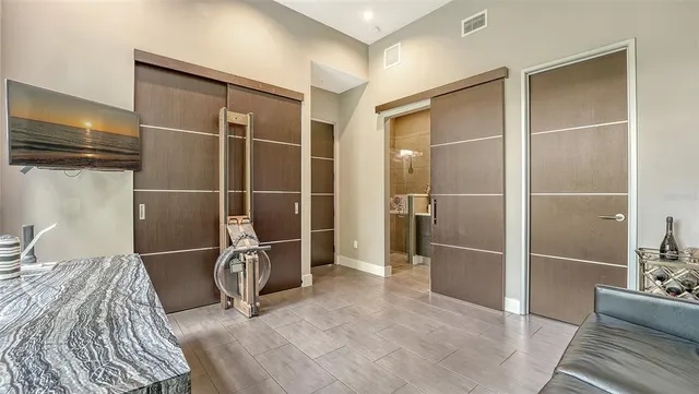a view of a room with wooden floor chair and windows