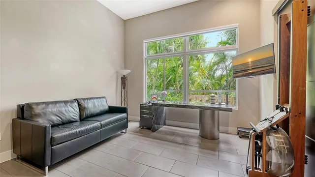 a bedroom with a bed and a flat tv screen on dresser