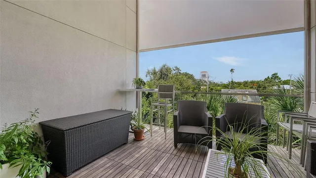 a front view of a house with a tree