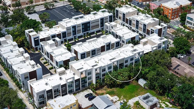 a front view of a house with a yard and potted plants