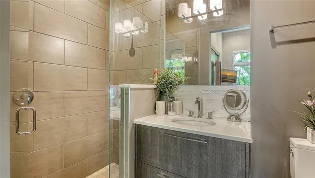 a bathroom with a glass shower door