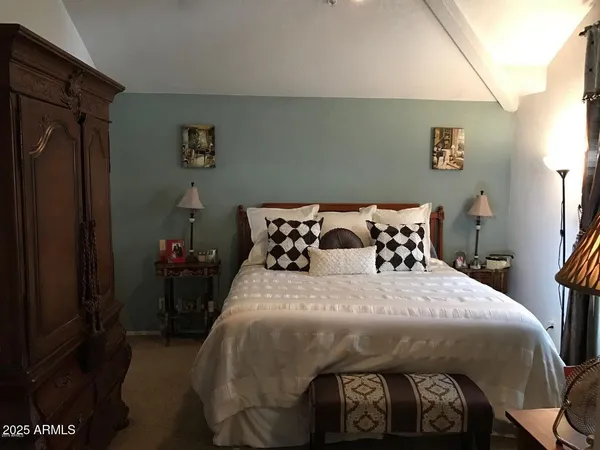 a bedroom with a bed and a table
