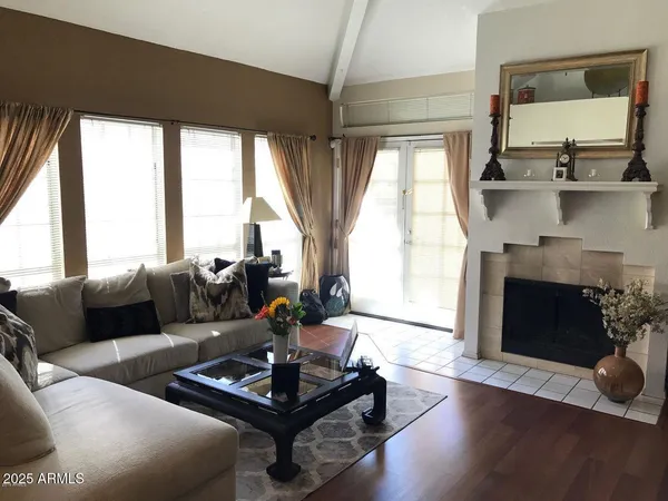 a living room with furniture fireplace and window