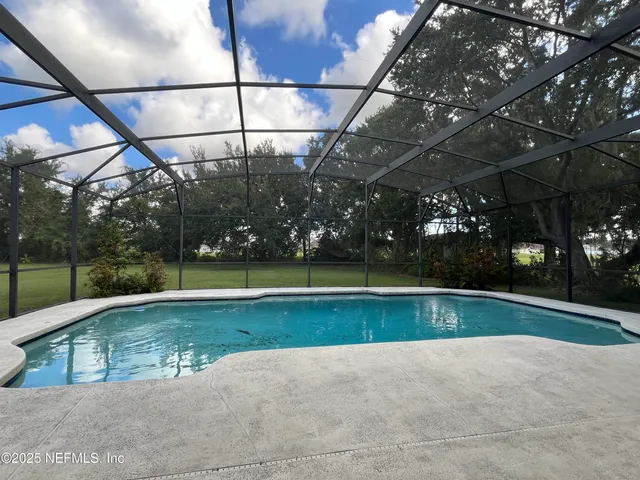 a view of an empty room with a fireplace and a floor to ceiling window