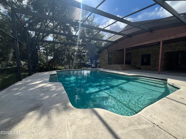 a view of a dining room with furniture a chandelier and wooden floor