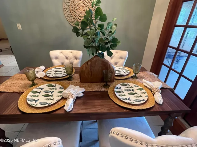 a living room with furniture a fireplace and a chandelier