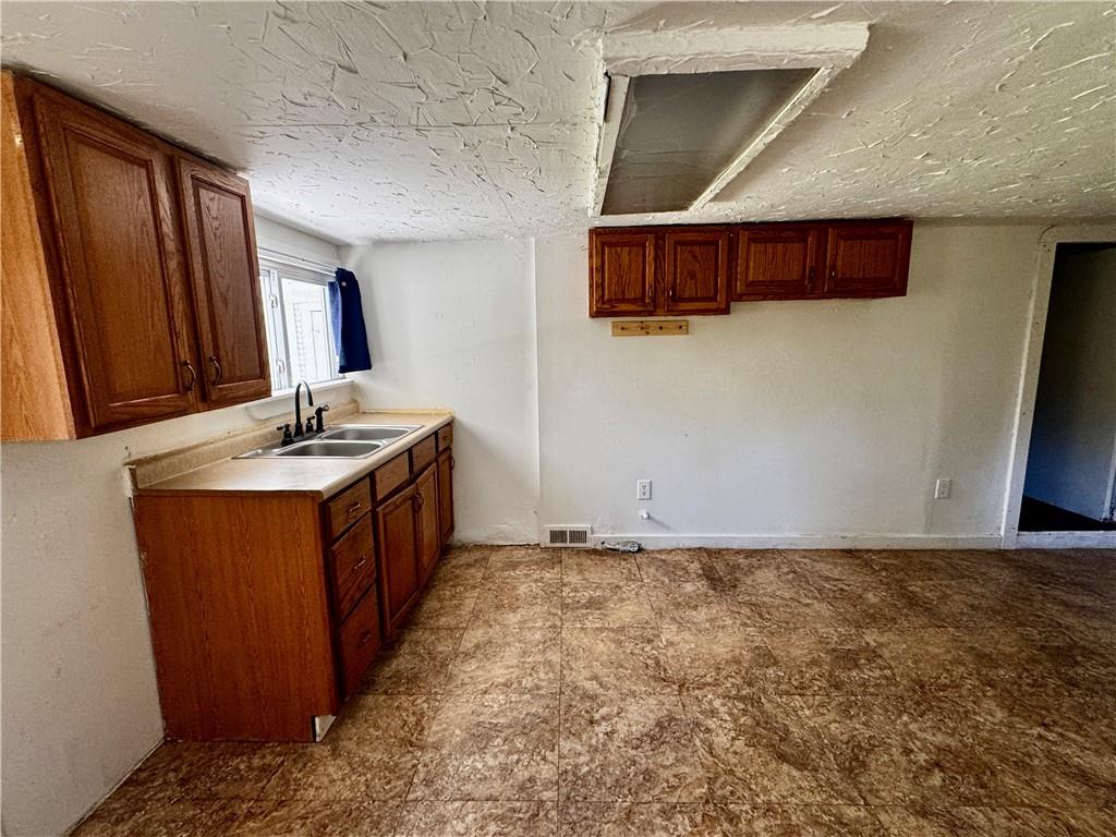299 Stone Quarry Road Monaca, PA 15061 - Photo 17 of 27 a kitchen with stainless steel appliances granite countertop a sink stove and a refrigerator