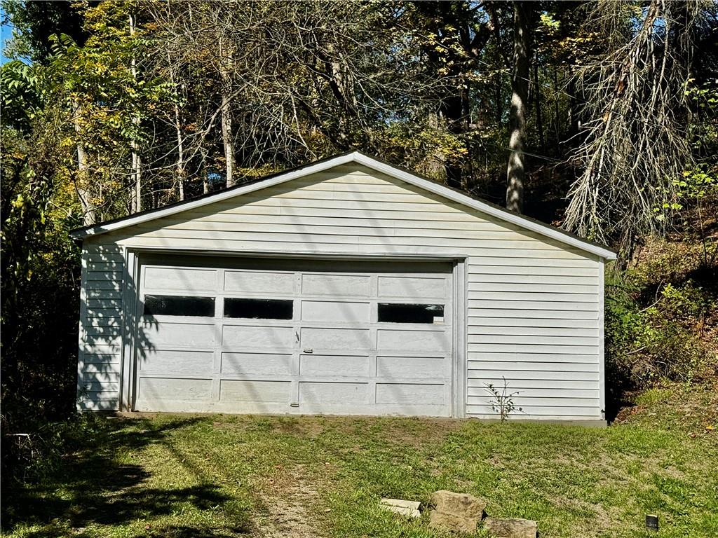 299 Stone Quarry Road Monaca, PA 15061 - Photo 24 of 27 a backyard of a white house with large trees