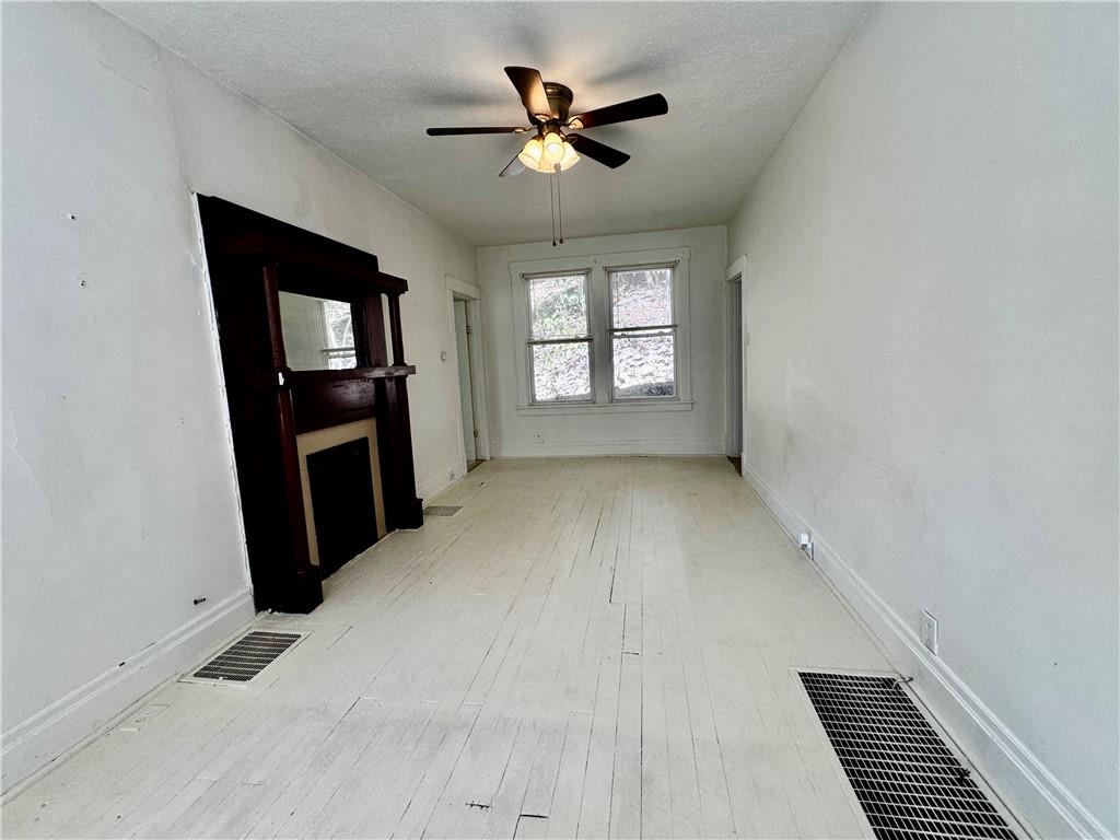 299 Stone Quarry Road Monaca, PA 15061 - Photo 6 of 27 wooden floor in an empty room with a window