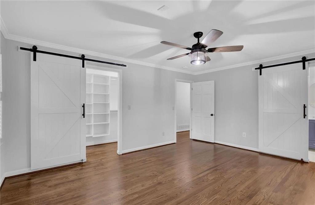 310 Clear Spring Court Marietta, GA 30068 - Photo 7 of 14 a view of a livingroom with wooden floor a ceiling fan and windows