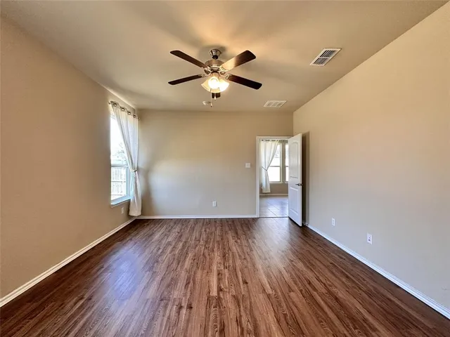 a view of kitchen and microwave with wooden floor