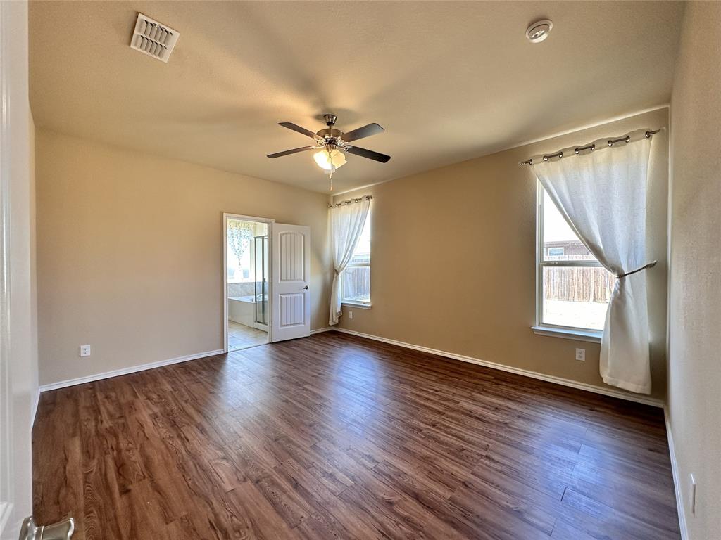 304 Cypress Crk Lane Denton, TX 76210 - Photo 10 of 24 a view of an empty room with a window and wooden floor